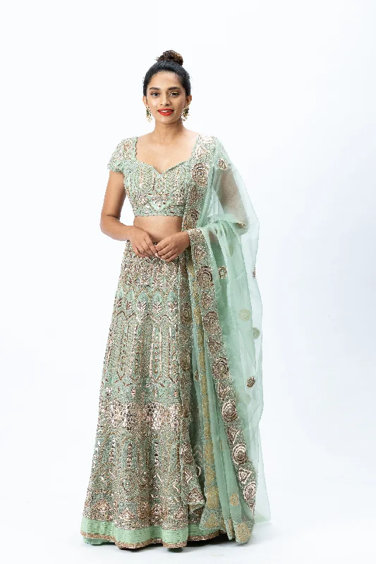 Mint Green Hand-embroidered Lehenga paired with Hand-embroidered Blouse, Hand-embroidered Dupatta and Hand-embroidered Long Jacket with Buttis Nylon Fabric Polyester Fabric Spandex Fabric